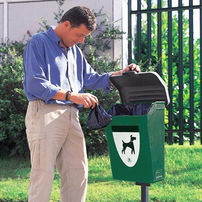 Man emptying dog waste into a dog waste bin