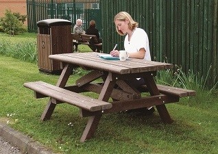 Table de pique-nique Clifton™ à l’extérieur université avec un étudiant