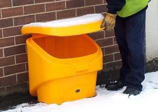Nestor™ 90 Grit Salt Bin being used by a hotel worker outdoors