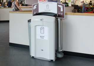 Nexus® 100 indoor recycling station for general waste and liquid reservoir with cup stacker in café