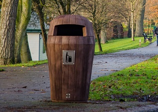 Sherwood™ outdoor litter bin with hooded top and stainless steel plaque in park