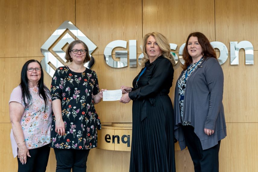 Handing over cheque to representatives of the Disability First charity.