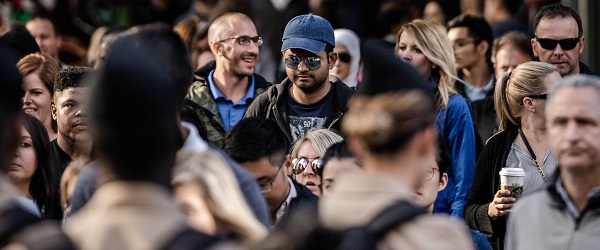 A crowd of people walking down the street