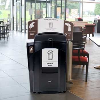 A black version of a Nexus 100 liquid and cup recycling station in a public bistro or caf&eacute;