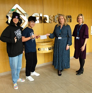Members of Glasdon handing over donation to Skool of Street