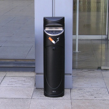 Black public ashtray bin in front of a building against a pillar