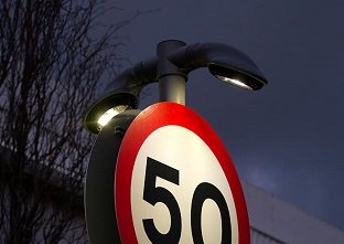 Double sided Lumino City 750 LED downlight illuminating a speed change highway road sign