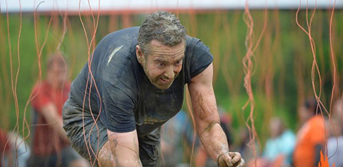 staff member participating in tough mudder