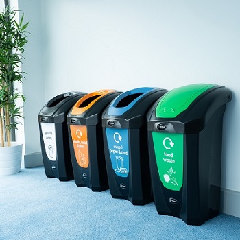 four black nexus 30 recycling bins in an office setting with different waste streams