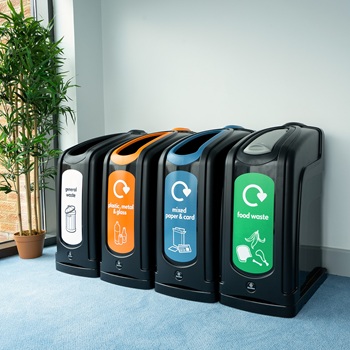 four black nexus 50 recycling bins in an office setting with different waste streams
