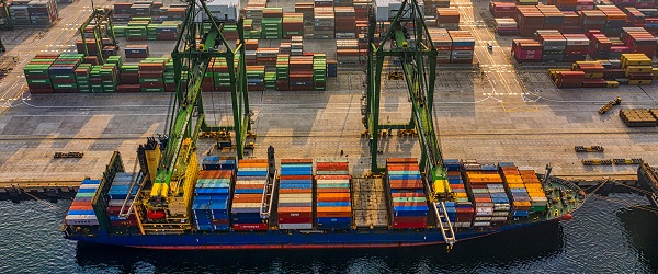 A cargo ship beside a loading dock