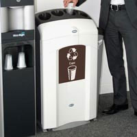 A person disposing of a cup into the Nexus 100 collector