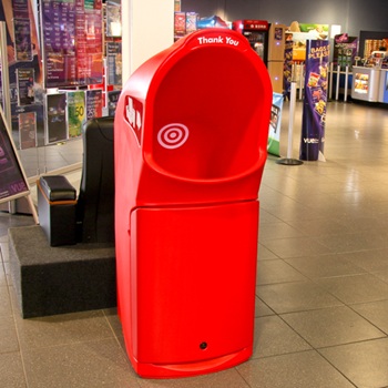 A large combo delta food waste bin outside of several retail stores and shops