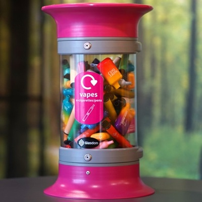 c-thru disposable vape recycling bin with a blurred background