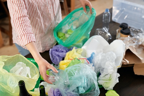 Someone sorting their household waste