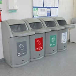 four combo tray shelf catering waste bins lined up next to each other with graphics in a canteen