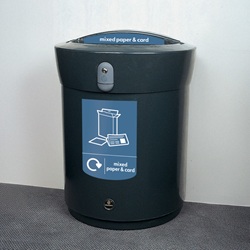 envoy recycling bin with blue paper and card waste graphics next to a wall