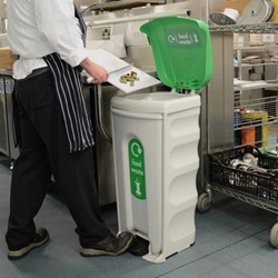 nexus shuttle recycling bin in a commercial kitchen with a chef using the foot pedal operated flap