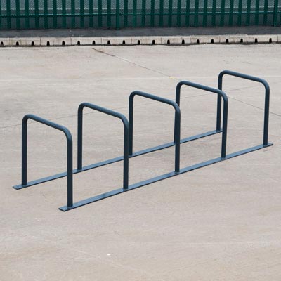 an empty bicycle rack on pavement