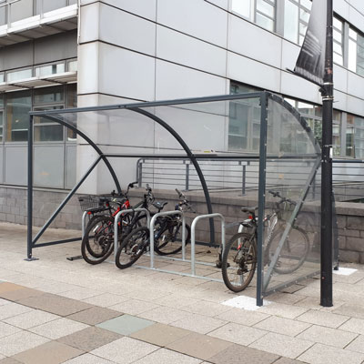 an echelon shelter housing a bicycle rack underneath it