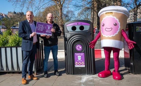 nexus 360 cup recycling bin in Edinburgh with a mascot dressed as a cup and two officials holding up a sign encouraging cup recycling