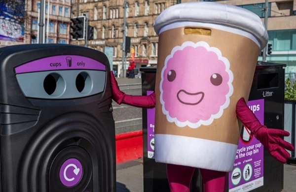 nexus 360 cup recycling bin in Edinburgh with a mascot dressed as a cup posing next to it