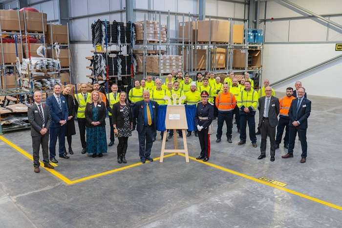 a crowd of glasdon directors and employees posing for a picture alongside the lord-lieutenant of lancashire