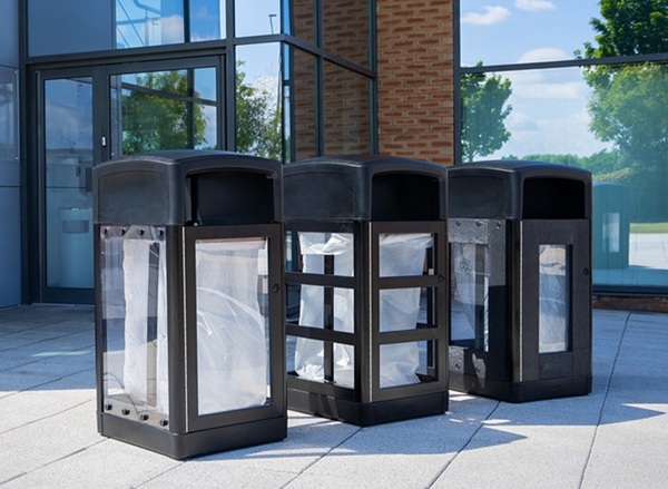 origin vision, origin insight, and origin aspect transparent security bins lined up outside an airport building