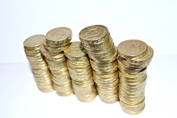 Several piles of pound coins stacked high